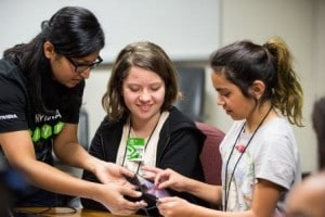Techbridge students and NVIDIA mentor work on coding challenge.