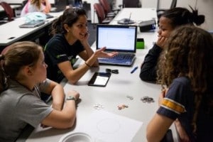 Techbridge students discuss coding ideas with NVIDIA mentor.