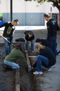A Project Inspire team prepares the ground for mulch.