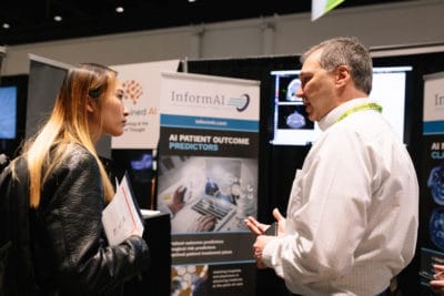 InformAI CEO Jim Havelka speaks with a GTC attendee at the startup's booth.