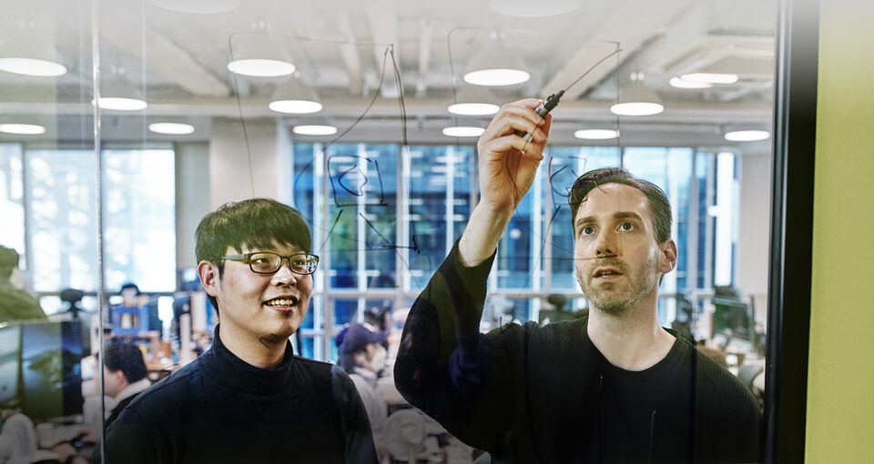 Lunit employees drawing representation of their AI model