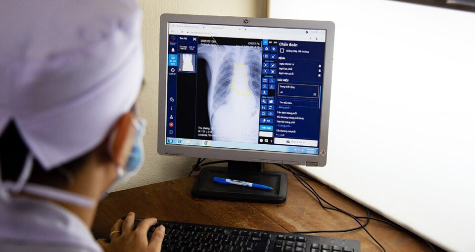 image of a medical professional viewing a radiology scan with AI analysis by VinBrain