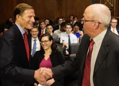 Picture of Sen Blumenthal welcoming Dally to the hearing