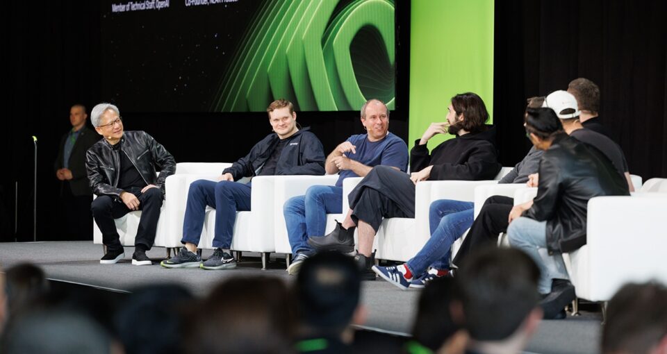 Jensen seated onstage with authors of the paper "Attention Is All You Need"