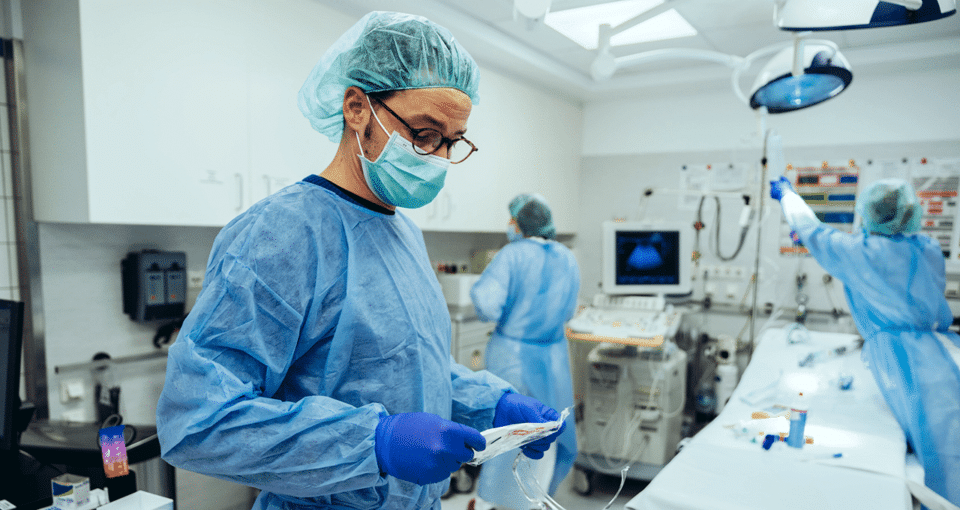 doctors in hospital room with medical devices