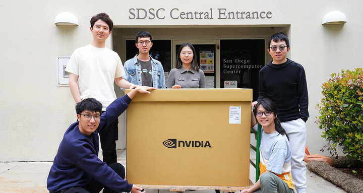 Researchers pose around box with NVIDIA DGX B200.