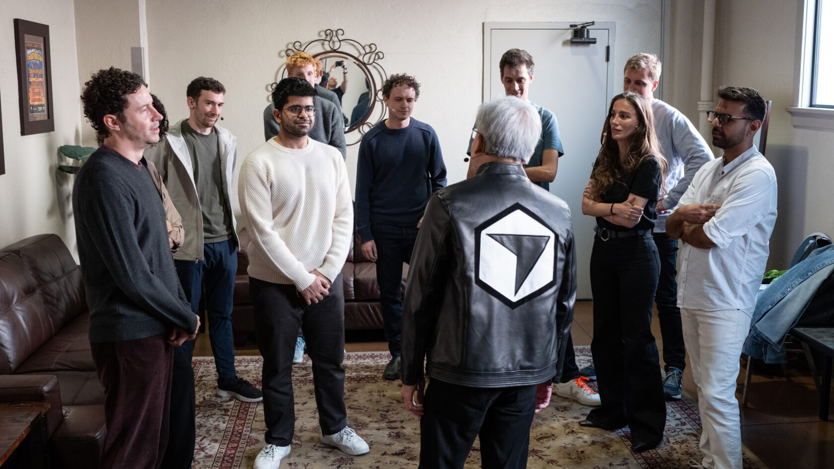 NVIDIA CEO Jensen Huang, sporting a custom leather jacket from Cursor, meets with open model ecosystem leaders before a panel discussion at GTC. 