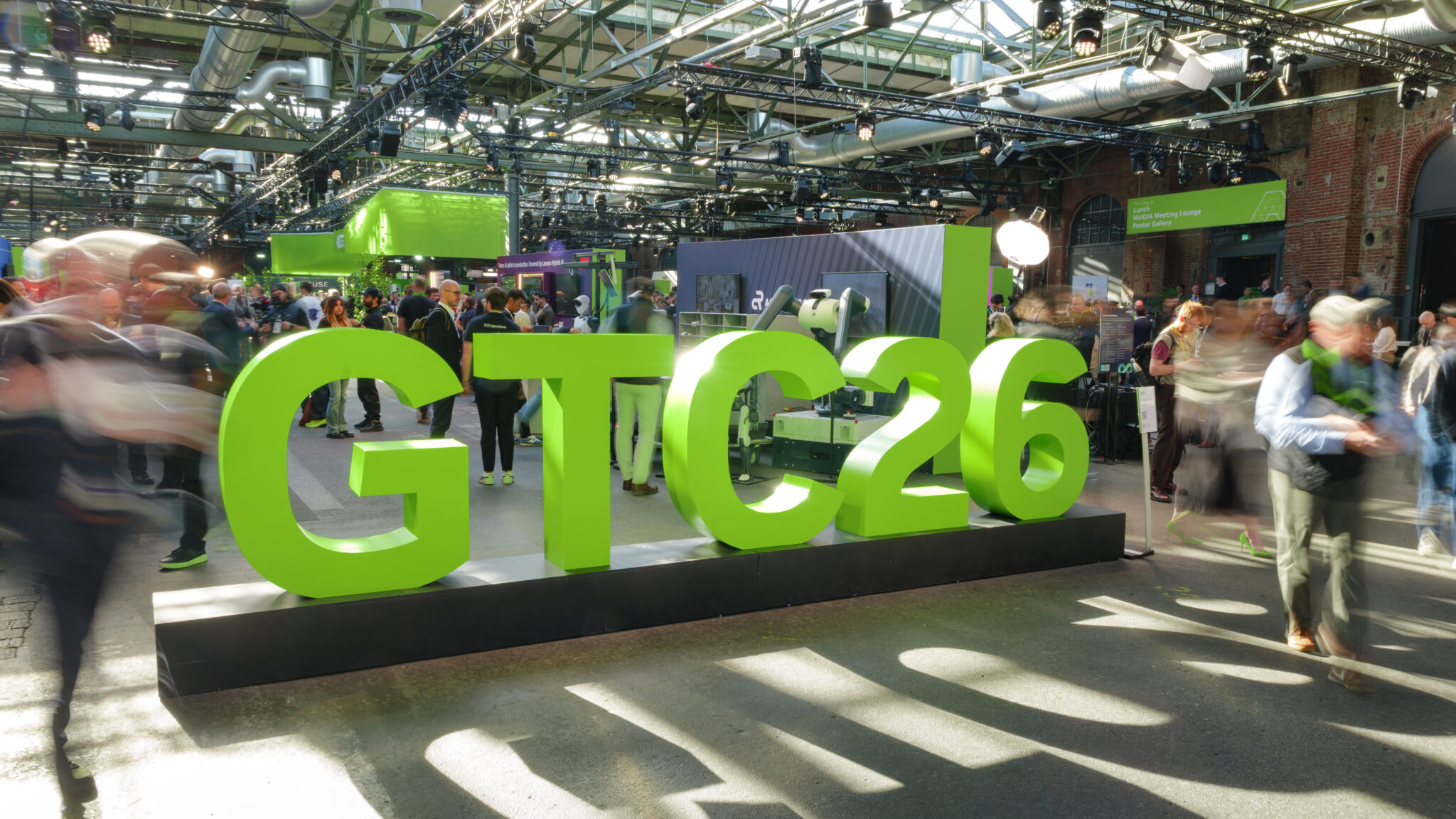 People stop for a photo-op with the NVIDIA GTC 26 sign.