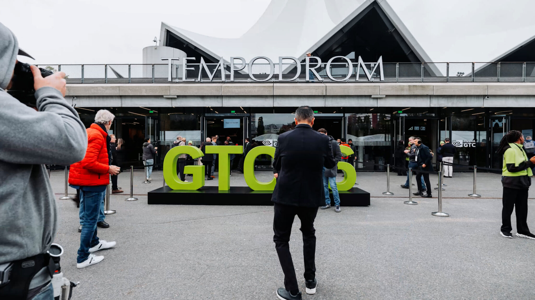 People stop for a photo-op with the NVIDIA GTC 26 sign.